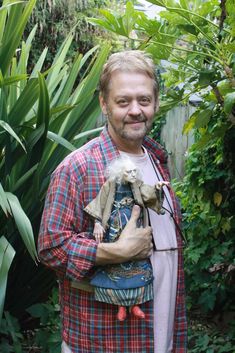 a man holding a stuffed animal in his hands