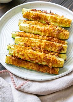 grilled zucchini on a white plate with parmesan cheese and seasoning