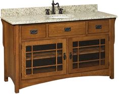 a bathroom vanity with marble top and wooden cabinet doors on both sides, two faucets at the sink