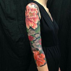 a woman with a flower tattoo on her arm