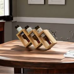 three bottles of wine are sitting on a wooden table in the middle of a living room