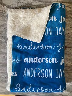 a blue and white blanket on top of a wooden table