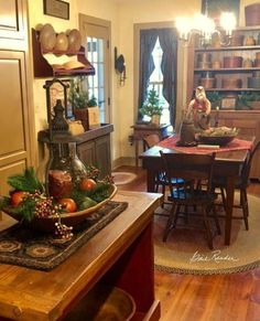 a dining room and kitchen area with wood flooring, wooden furniture and christmas decorations on the table