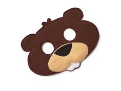 a brown bear mask with two holes in the middle and one hole at the bottom