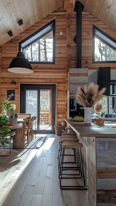 a kitchen and dining area in a log cabin