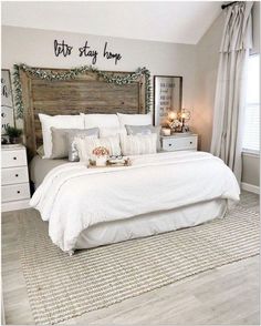 a bed with white linens and pillows in a bedroom decorated for christmas or new year's eve