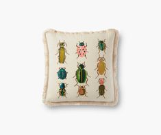 a pillow with different colored bugs on it