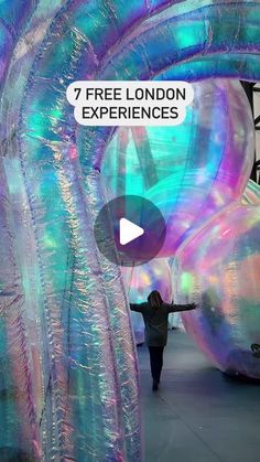 a person standing in front of an art installation with the words free london experiences on it