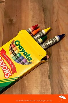 some crayons are sitting in a box on the floor