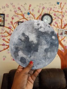 a person holding up a paper plate with the moon on it