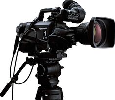 a video camera on a tripod with a lens attached to it