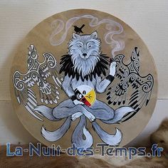 a plate with an image of a cat and two birds on it, sitting next to some fur