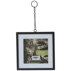 a black and white photo hanging from a metal chain with the number 4x4 on it