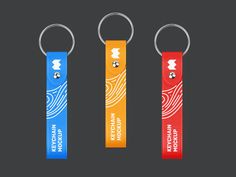 three keychains with different designs on them, one is red, the other is blue