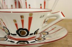 a close up of a cup and saucer on a table