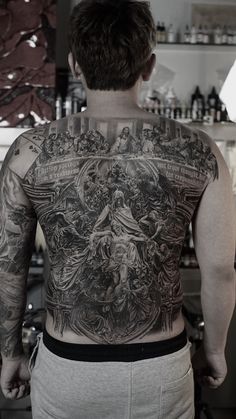 the back of a man with tattoos on his body