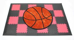 a rug with a basketball on it sitting on top of a checkerboard floor