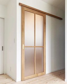 an empty room with white walls and wooden flooring is seen in this image from the doorway