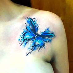 a blue butterfly tattoo on the chest