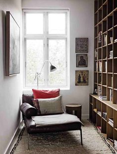 a living room filled with furniture and bookshelves