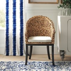 a wicker chair sitting in front of a radiator next to a window