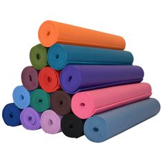 a stack of yoga mats stacked on top of each other in different colors and sizes