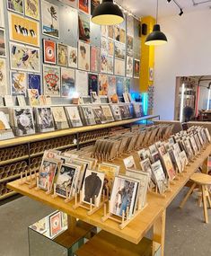 a long table with many pictures on it in a room filled with tables and chairs