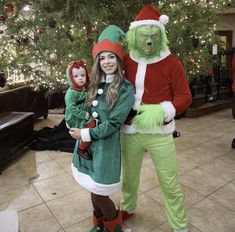 two people dressed up as grin and the cat in the hat standing next to each other