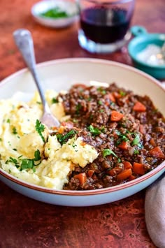 a bowl filled with mashed potatoes and meat