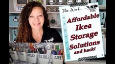 a woman is holding up a sign in front of some shelves with other items on it