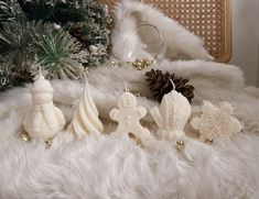 christmas decorations on white fur with pine cones