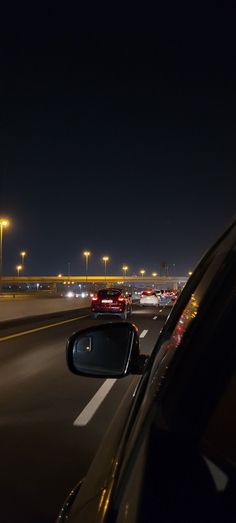 cars driving down the highway at night time