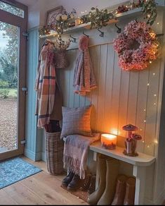 the entryway is decorated with wreaths, lights, and scarves on display