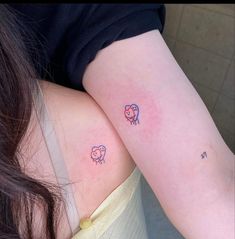 two small tattoos on the arms of women