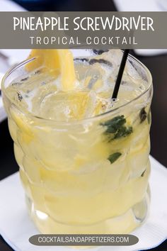 the pineapple screwdriver cocktail is served in a tall glass with ice and garnishes