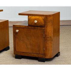 two wooden nightstands sitting on top of a carpeted floor next to each other