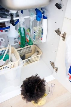 a cluttered bathroom with shampoos and other cleaning products