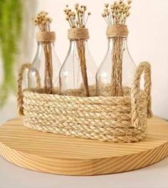 some glass bottles are sitting on a wooden tray with rope and twine wrapped around them