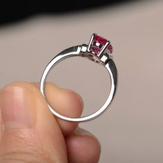 This is a gorgeous handmade creation. Its beauty is its simplicity & Elegance. The 6*8mm oval cut lab ruby is crafted in solid sterling silver and with rhodium plated. It is available to customized, if you have any mind, just let me know, we will discuss with it. All item is sent in a beautiful gift box You can realize more lovely stuff clicking the link https://www.etsy.com/shop/knightjewelry?refshopsection_shophome_leftnav Please leave the correct address and you PHONE NUMBER for deliverin Red Oval Birthstone Ring With Prong Setting, Valentine's Day Oval Diamond Ring With Prong Setting, Red Oval Sapphire Birthstone Ring, White Gold Ruby Ring With Cubic Zirconia, Oval Ruby Birthstone Ring With Accent Stones, Oval Lab-created Ruby Birthstone Ring With Center Stone, Oval Lab-created Ruby Birthstone Ring, Red Sapphire Ring With Accent Stones, Oval Shape, Red Sapphire Ring With Oval Shape And Accent Stones