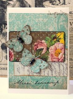 a close up of a card with flowers and butterflies on the front, and an old fashioned postcard in the back