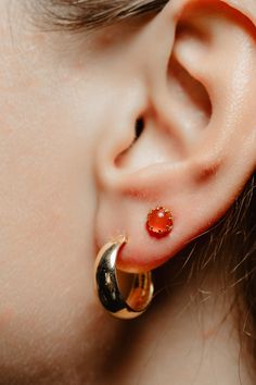 A perfect Autumn earring! Shimmering with orange fire this antique revival single stud is handmade and is designed by our goldsmiths. Made of solid 10k yellow gold, this beautiful oriental style gold earring is set with carnelian cabochons. The carnelian has a lovely shimmer and measures 0.2 inch in diameter. It sits in figural elongated claws and reflects the light beautifully when worn! Will look lovely mixed and matched with your antique and artisan earrings! Can be bought as a pair or a sing Cheap Orange Pierced Earrings, Orange Carnelian Gemstone Earrings, Gold Carnelian Gemstone Earrings, Carnelian Gemstone Round Earrings, Round Carnelian Gemstone Earrings, Gold Carnelian Jewelry With Matching Earrings, Round Orange Carnelian Earrings, Orange Carnelian Round Earrings, Orange Carnelian Earrings