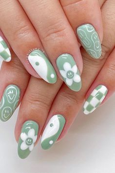 Stay trendy this summer with these adorable sage green almond nails, featuring a playful assortment of white designs including checkerboard patterns, smiley faces, daisies, and yin and yang symbols. Embrace the fun and bring out your unique style! ☯️ 🌸✨ // Photo Credit: Instagram @ricekittynails Paznokcie Hello Kitty, Kutek Disney, Green Nail Art, Hippie Nails, Cute Simple Nails, Green Nail Designs, Nagel Tips