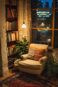 a living room with a chair, rug and bookcase in front of a window