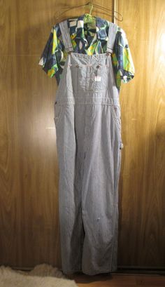 These 60s vintage overalls are gently distressed blue and white stripe cotton denim, Penneys Big Mac Square Bak overalls. Union Made and Sanforized. The denim in this pair of overalls is gently worn with fade marks and small rips, and still quite sturdy.  Made in the USA. Lots of overalls details and pockets with lots of white and red accent stitching. They have  wear at the edges and the back hems. They have adjustable straps and a big pocket on the front and long straps. These have overall hoo Vintage Cotton Relaxed Fit Overalls, Retro Cotton Overalls With Relaxed Fit, Casual Striped Overalls With Pockets, Striped Cotton Overalls, Striped Cotton Overalls For Spring, Spring Striped Cotton Overalls, Vintage Relaxed Fit Overalls, Costumes With Overalls, Vintage Overalls