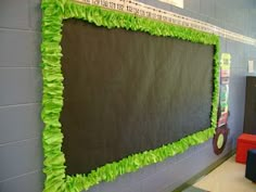 a bulletin board covered in green tissue paper