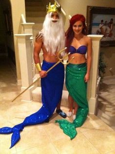 two women dressed as mermaids pose for the camera