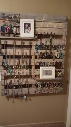 a wall mounted jewelry rack with pictures on it