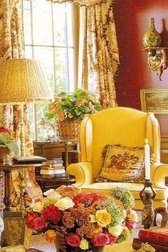 a living room filled with furniture and flowers