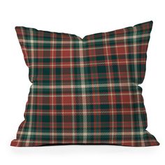 a red and green plaid pillow on a white background