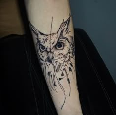 an owl tattoo on the left arm